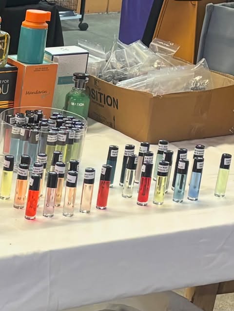 His table at Renninger's Melbourne Flea and Farmer's Market — rows of his roll-on bottles